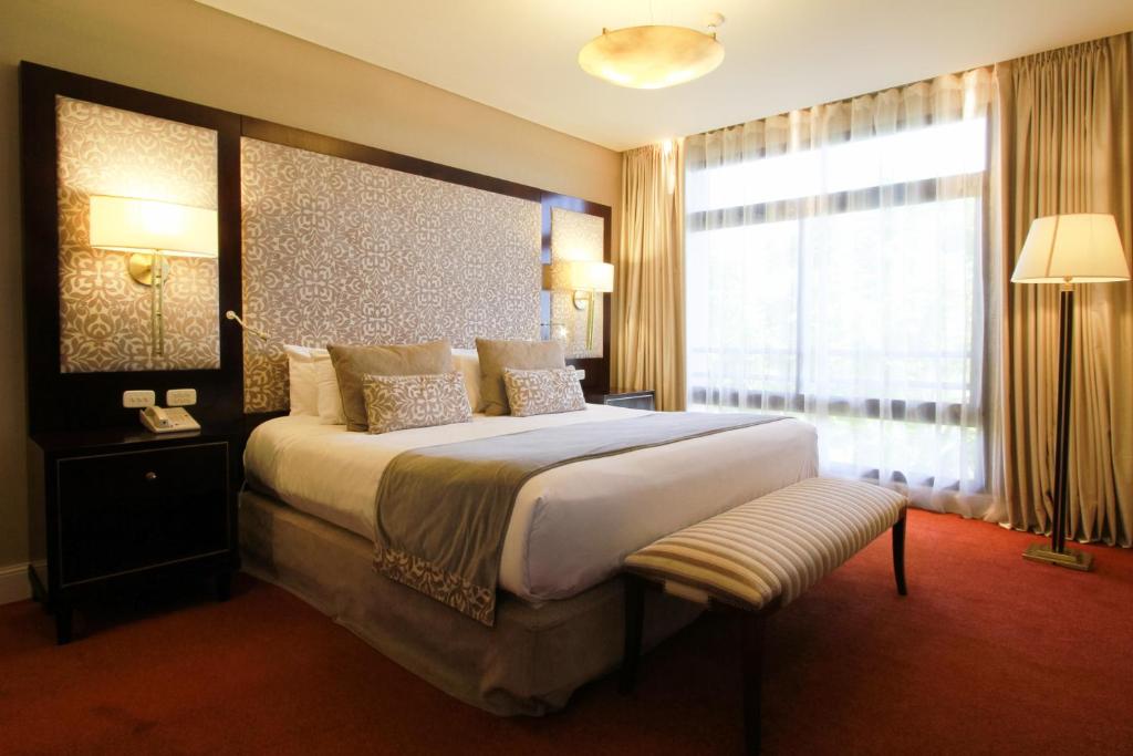 Room with a luxurious queen-size bed at the Grand Hotel Resort and Casino.